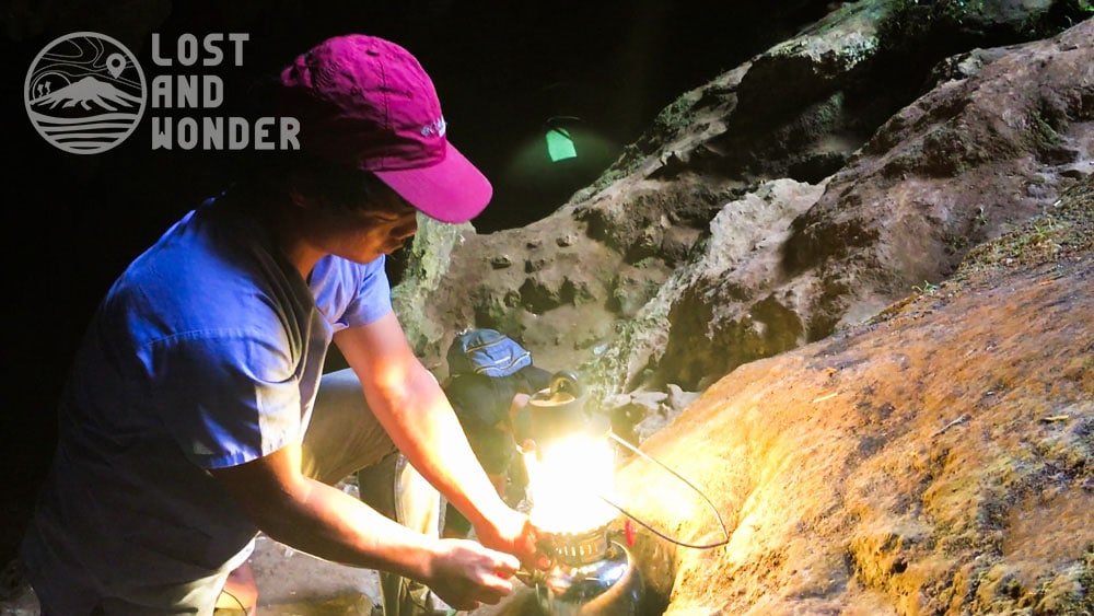 Photo of a tour guide lighting up a lamp in Sumaguing Cave