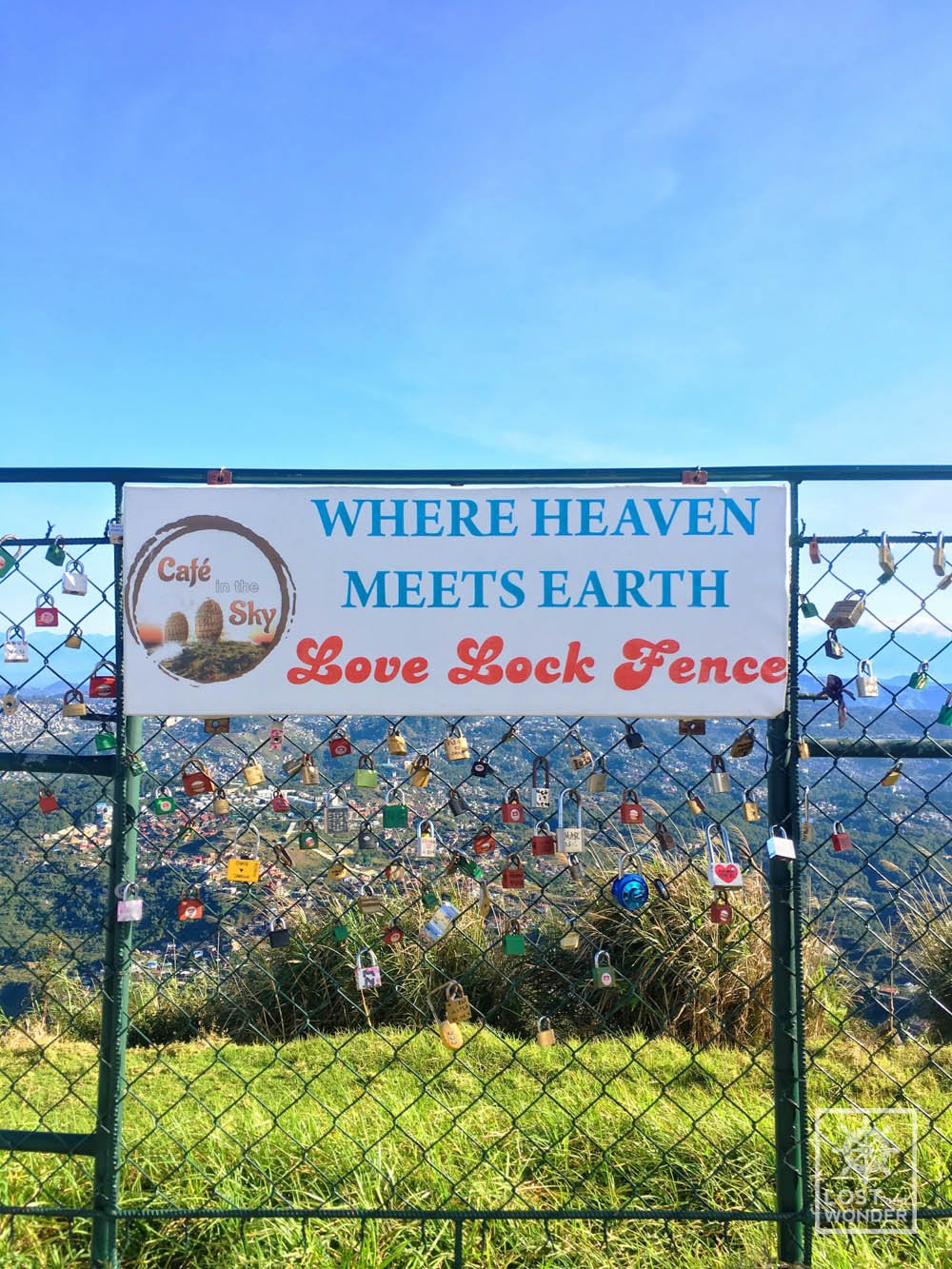 Photo of love lock fence in cafe in the sky